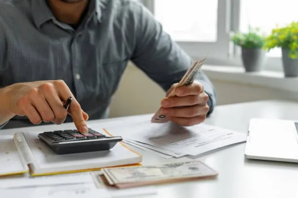 Business owner reviewing invoice factoring fees and rate breakdown